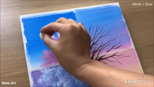 a person has their hand on the top of a painting of a bare tree