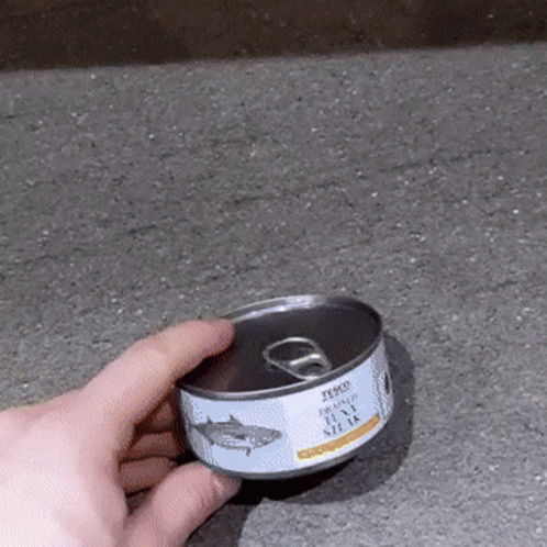 a person is reaching for an empty canned can