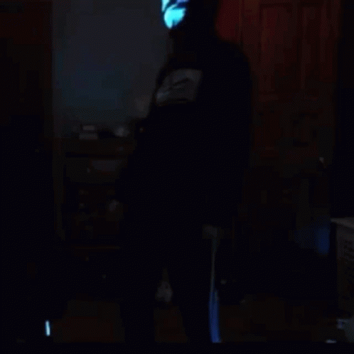 a man wearing a yellow light mask in dark