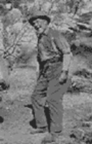 an old black and white image of a man standing