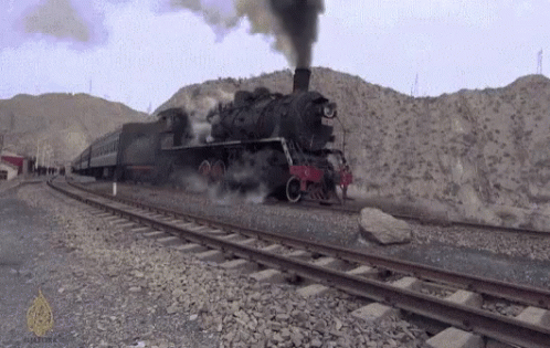 a train that is blowing smoke on the tracks
