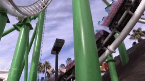 a roller coaster going through an amut park