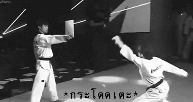 a man doing karate with another man watching