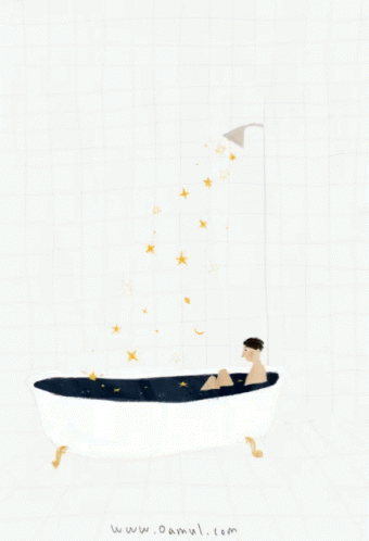 someone in a bath tub with star shaped objects floating above it