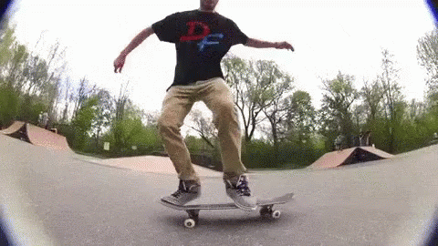 a man in black shirt doing a trick on a skateboard
