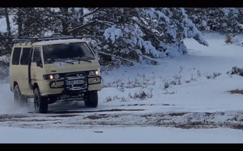 an suv going through the snow on a trail