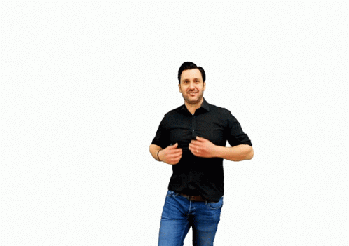 a man in black shirt and jeans holding his arms out