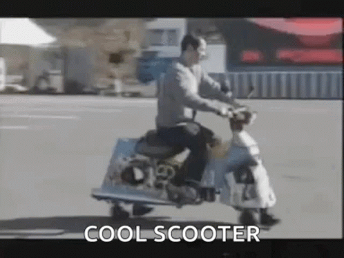 an image of a man riding a motor scooter