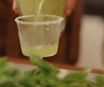 a beverage being poured into a clear cup