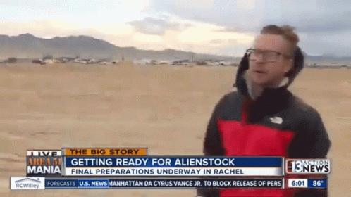 a news anchor on a beach with people standing around