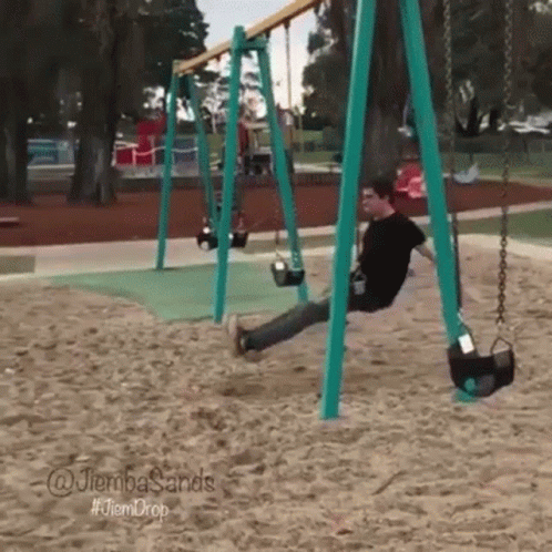 the child is at the park on a swing