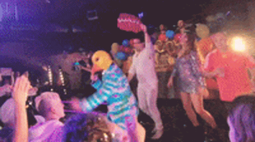two disco dancers wearing costumes in front of people