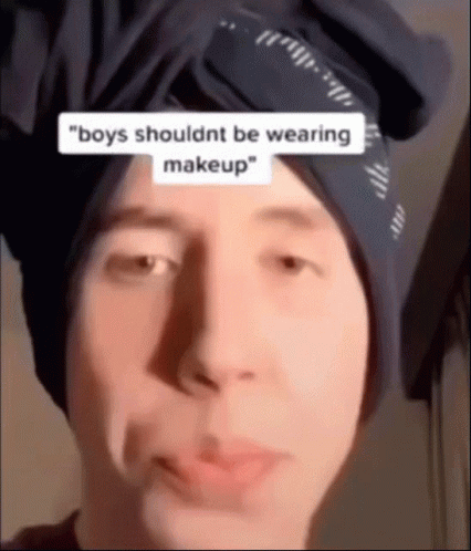 a man wearing a hat has the text boy's shouldn't be wearing makeup