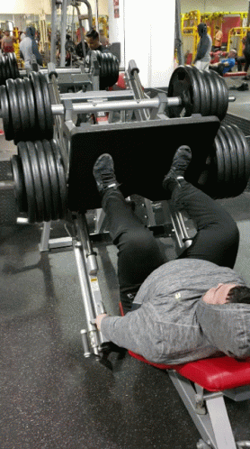 men doing bench presses with dumbs on each side