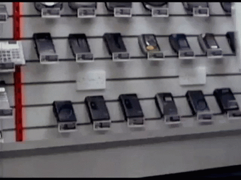a wall filled with cell phones and numbers on them