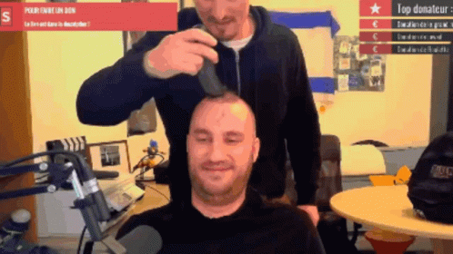 a person is using a device to cut another persons hair