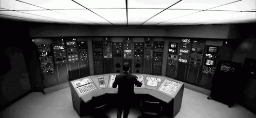 a person standing in front of a control room
