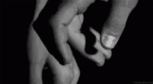 a black and white po of two hands holding soing