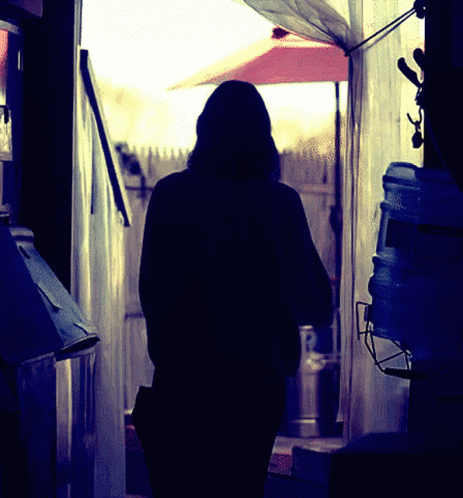 a woman looking out of an open doorway