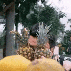 several pineapples, one green one are blue and white