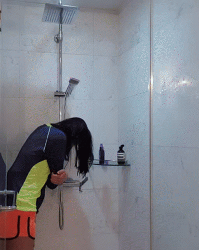 a women who is taking a shower in the bathroom