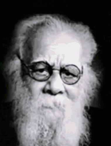 this black and white portrait of an old man shows off his long hair and mustache