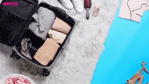 a suitcase is open and it's contents are being placed on the floor