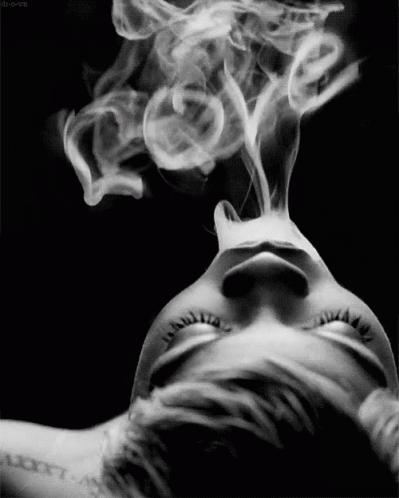 a woman that has some kind of smoke coming out of her mouth