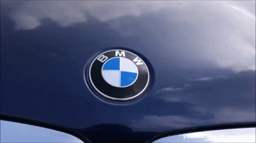 close up of a bmw emblem on the front hood