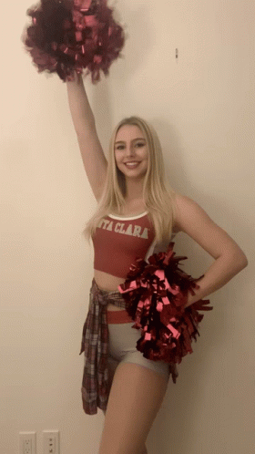 a woman holding a cheerleader pole in front of her