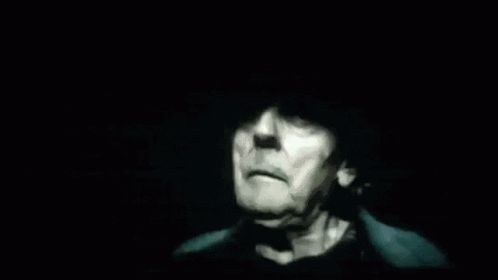 an image of an old man in a dark room