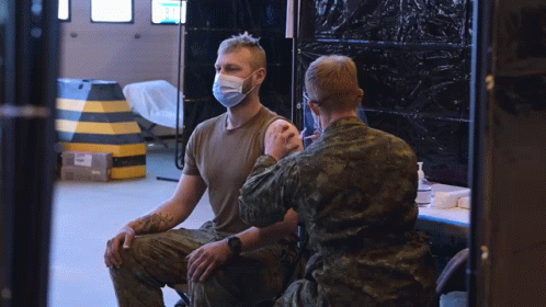 a soldier and a man wearing masks in a room