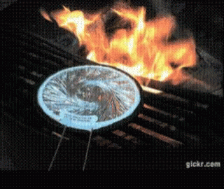blue flames surrounding a grill with black grilling