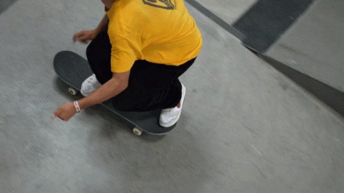 a man on a skateboard riding up a ramp