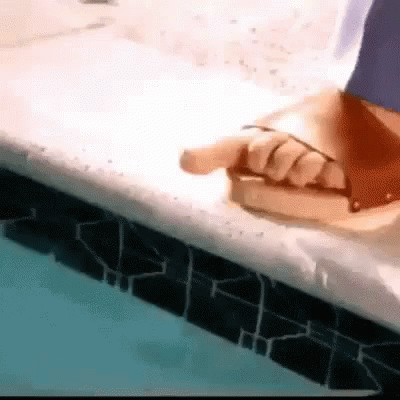 a person holds a piece of plastic next to a tub