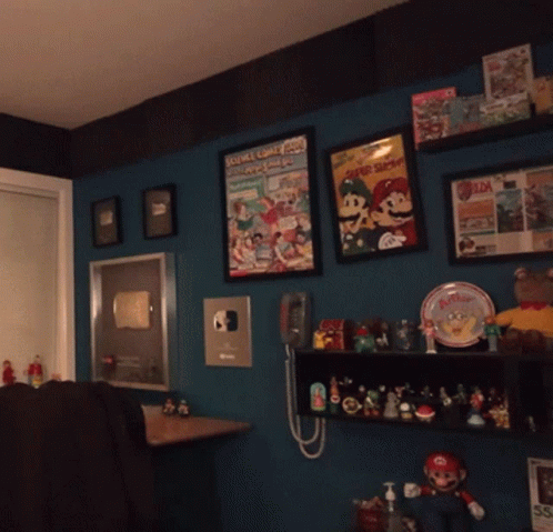 an assortment of disney themed items are displayed in this dimly lit room