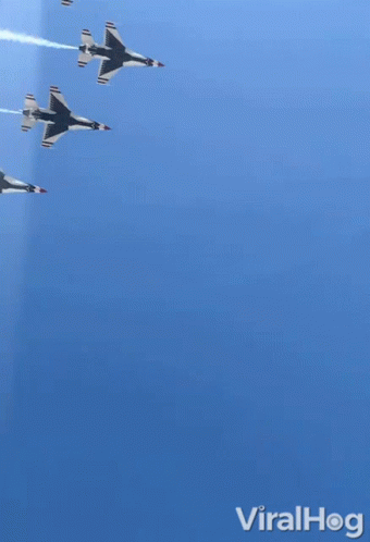 three jets flying in formation across a sky
