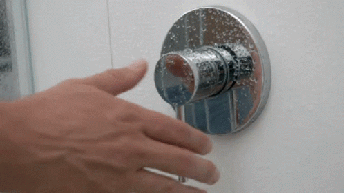 hand in blue gloves adjusting the wall mounted showerhead