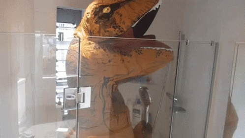 a toy dinosaur is displayed inside a display