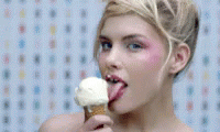 a woman with blue makeup holding an ice cream cone
