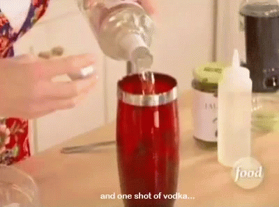 someone pouring a s of vodka into a glass