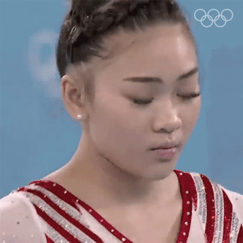 the athlete with white powder covering her face