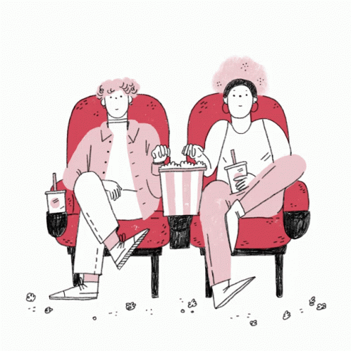 two people sitting in chairs eating popcorn