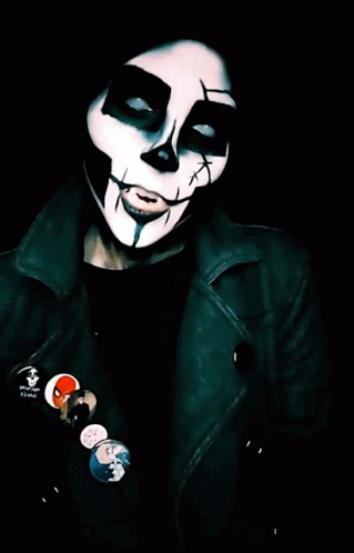 a person with a mask on has badges and a cigarette