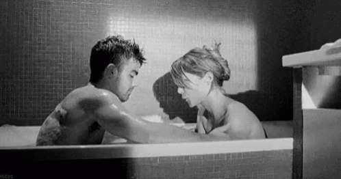 a man and woman in a bathtub talking