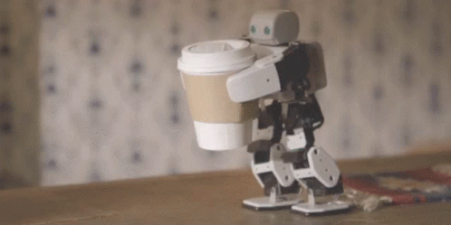 a small robot holding up a coffee cup