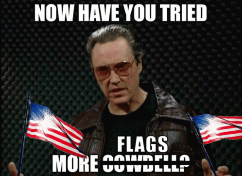 a man with glasses holds out a flag