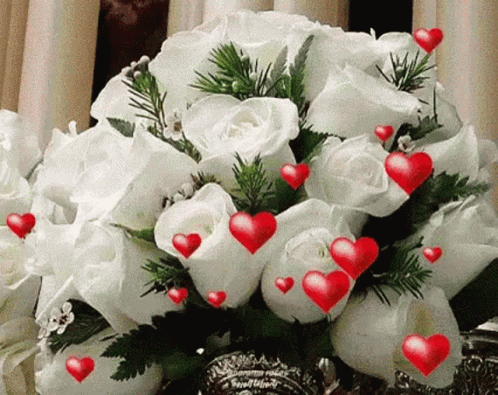a bouquet of white roses is surrounded by blue hearts