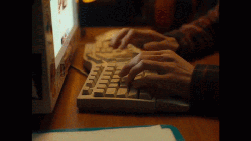 a person using a keyboard and mouse on a desk