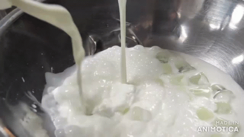 the liquid is pouring into the bowl of the mixer
